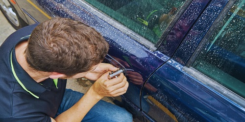Professional locksmith in OKC repairing a home lock