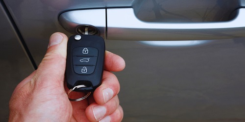 Experienced automotive locksmith in OKC unlocking a car