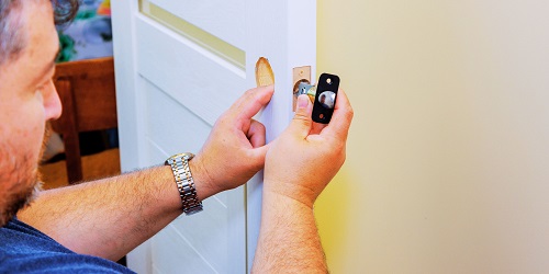 Reliable locksmith in Oklahoma City rekeying a door lock